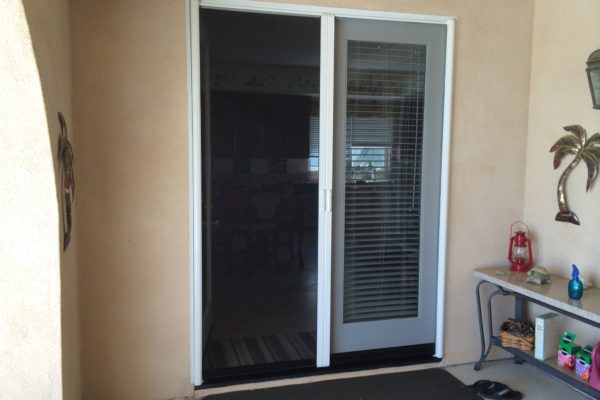 White Mirage French door retractable screen door installed in Corona