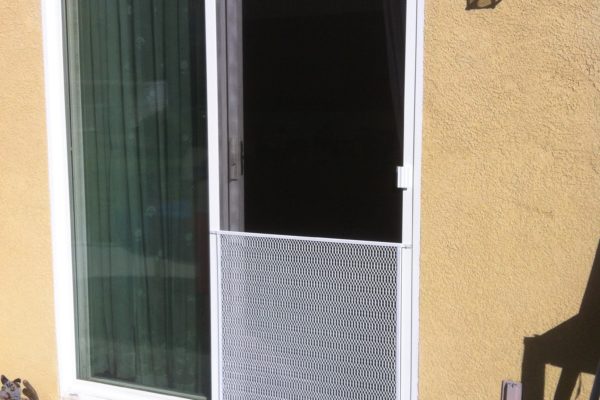 White sliding screen door installed with pet grill. Murrieta 11/8/13